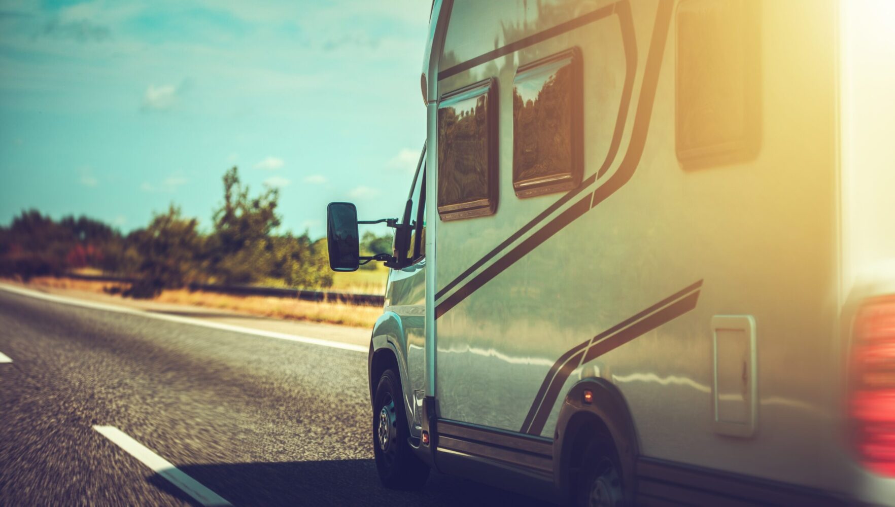 Camper Van Recreational Vehicle Summer Road Trip. Vehicle on a Highway.