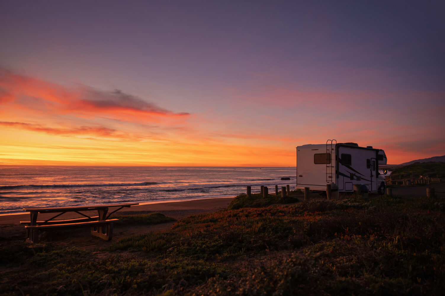 Scenic California Pacific Ocean Sunset From a Camper Van Class C Motorhome. Road Trip and Outdoors Pursuit Theme. Recreational Vehicles. Cambira, United States of America.